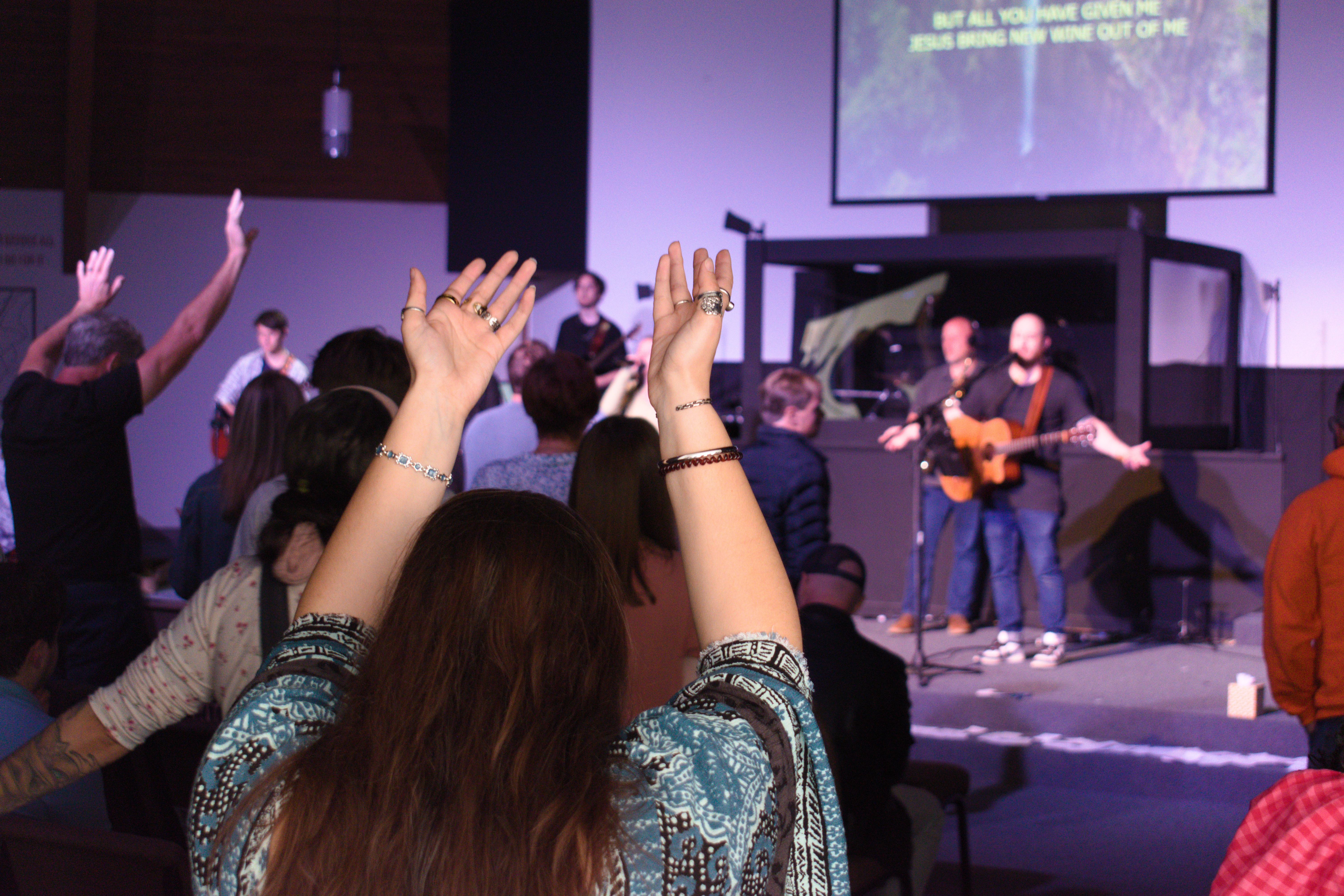 group of people worshiping at Revival City Church
